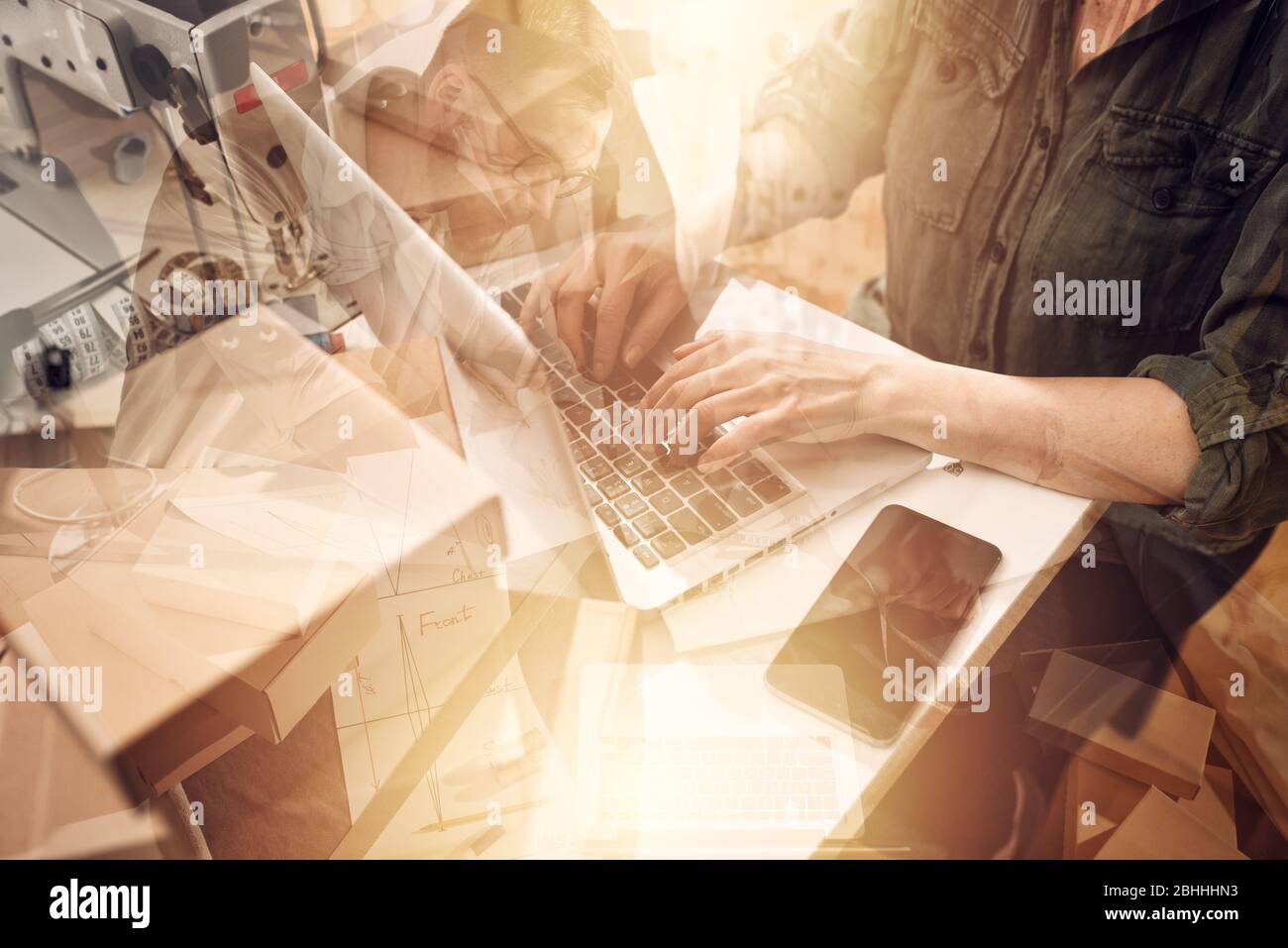 Seamstress works to new clothes ordered by internet client Stock Photo