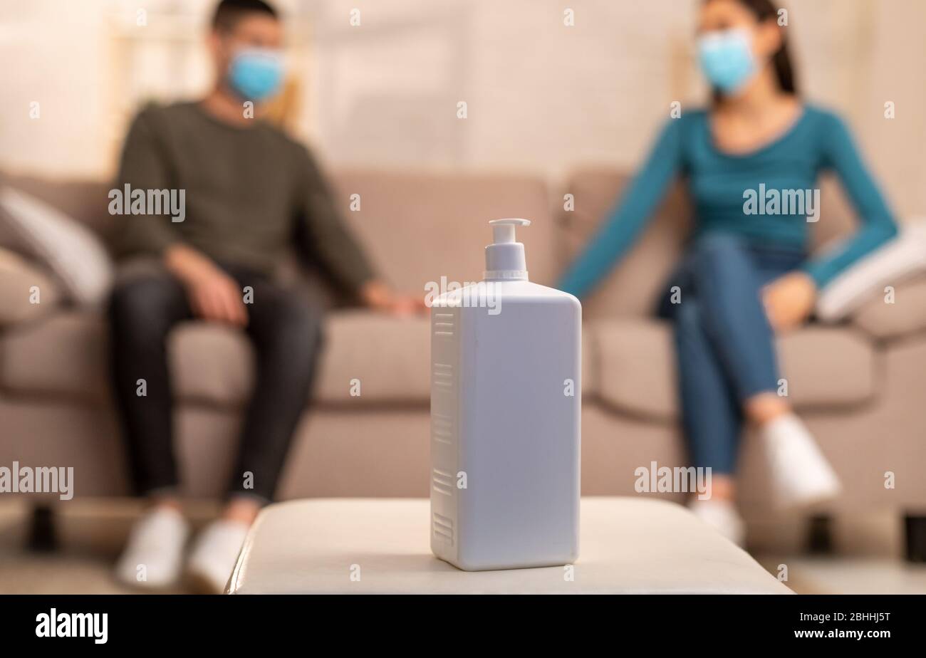 Couple sitting on couch spending time together Stock Photo