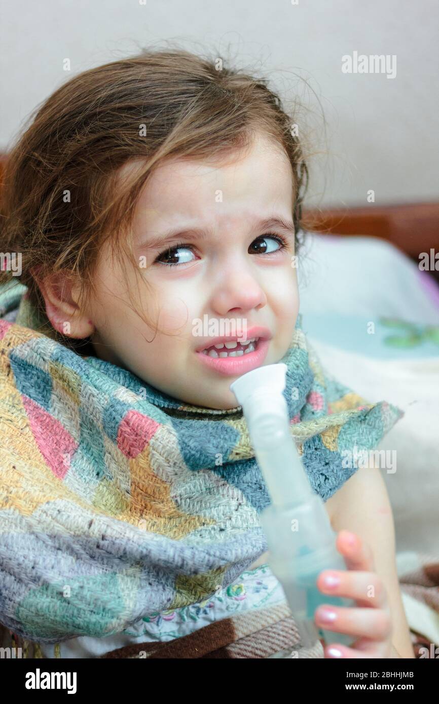 Child with respiratory illness making inhalation with inhaler Stock ...