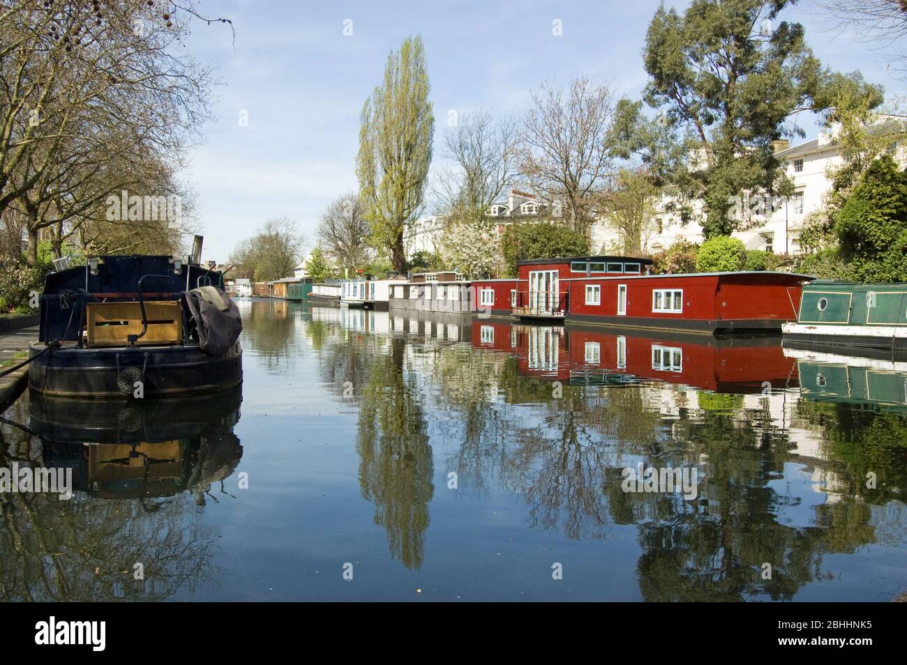 Rows of houseboats and narrow boats on the canal banks at Little Venice, Paddington, West London. The Grand Union Canal meets the Regent's Canal here. Stock Photo