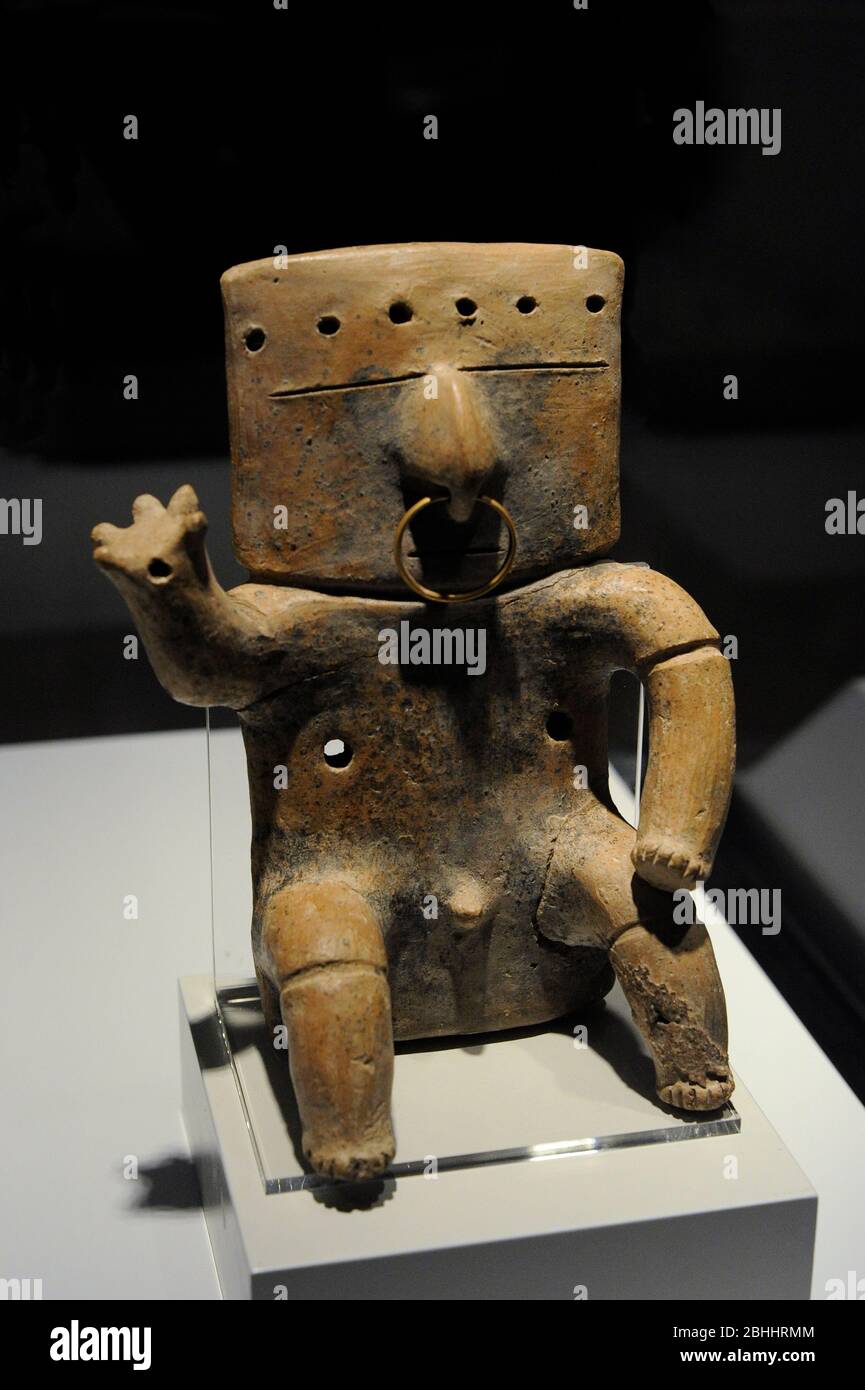 Seated human figure with tumbaga decoration. Ceramic and gold. Quimbaya culture. Integration period (1200-1500 AD). Colombia. Museum of the Americas. Madrid, Spain. Stock Photo