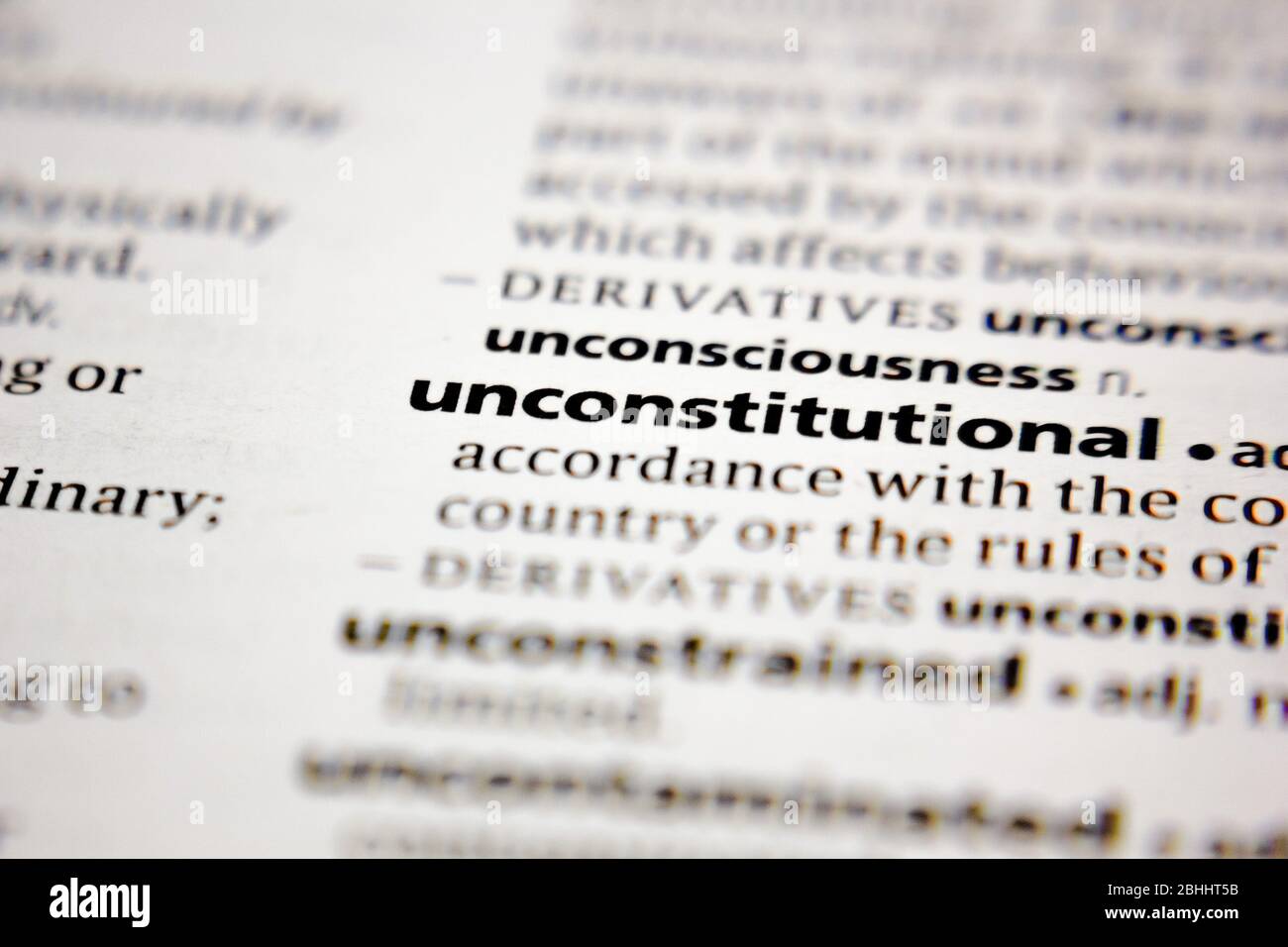 Word or phrase unconstitutional in a dictionary. Stock Photo