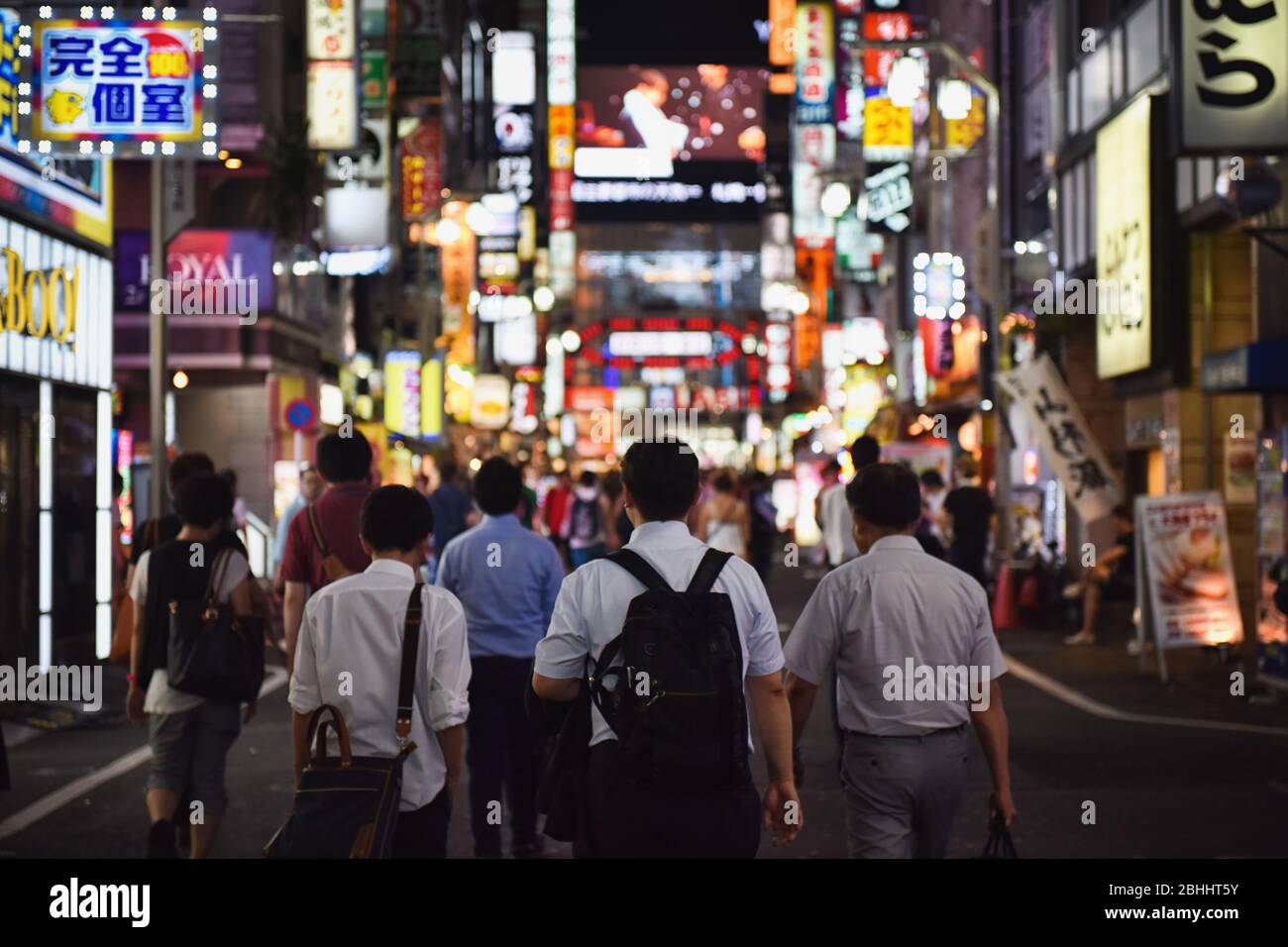 Neon signs line Shinjuku and Shibuya district. The area is a nightlife district known as Sleepless city. Stock Photo
