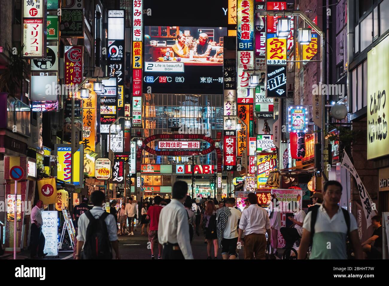 Neon signs line Shinjuku and Shibuya district. The area is a nightlife district known as Sleepless city. Stock Photo