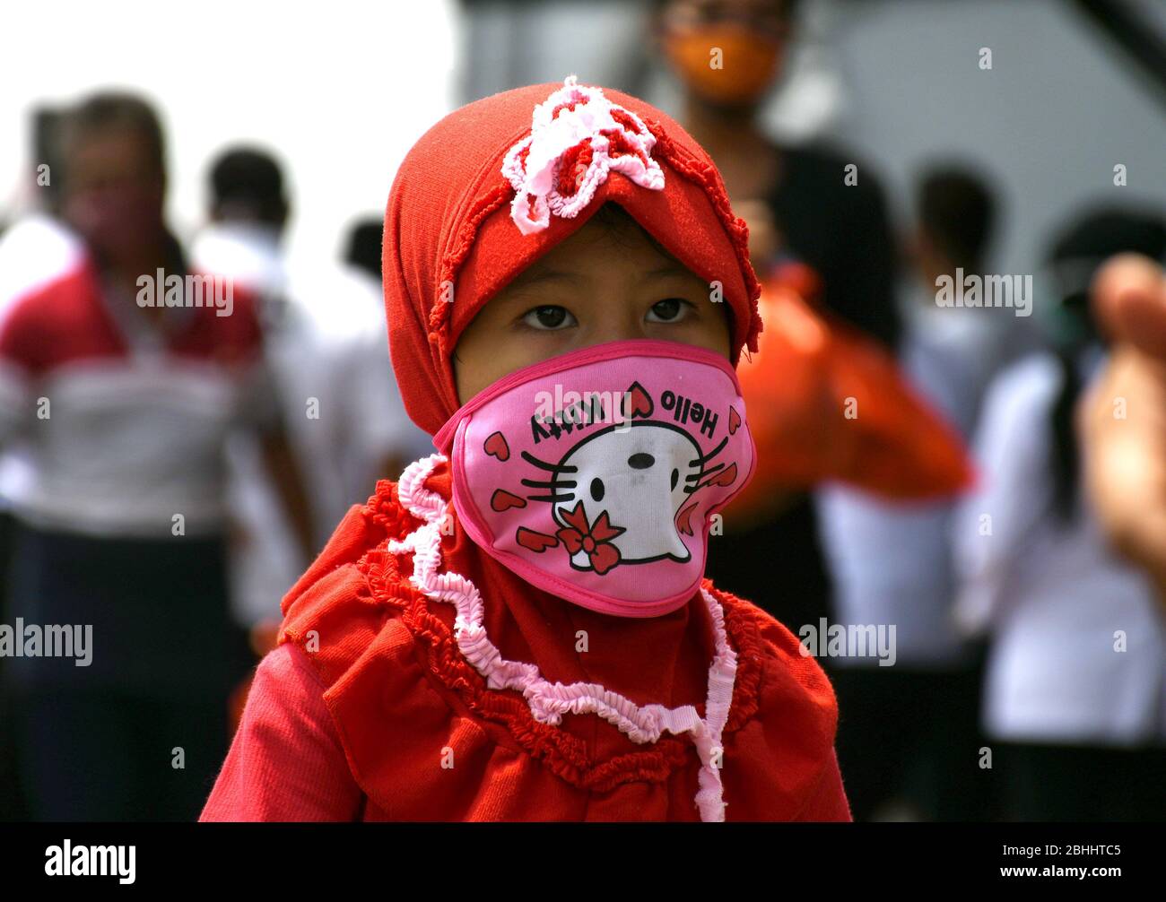 April 26, 2020, Jakarta, Jakarta, Indonesia: Children play bicycles using masks in their home environment during large-scale social enforcement (psbb) at the co-19 pandemic in Jakarta on April, 26,2020. Since the arrival of the covid-19 outbreak, all Indonesian citizens are required to wear masks when leaving the house to prevent transmission of the corona virus and to maintain physical social distancing, and to maintain cleanliness of the body that has been lived for 5 weeks (Credit Image: © Dasril Roszandi/ZUMA Wire) Stock Photo