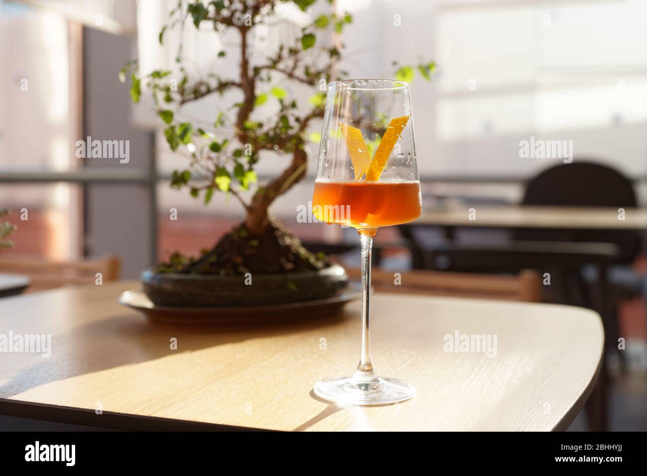 Japanese Cocktail With Lemon Zest Bonsai Tree In The Background Stock Photo Alamy