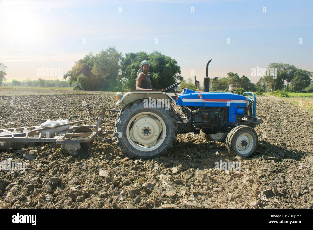 Indian farmer ploughing field tractor hi-res stock photography and ...