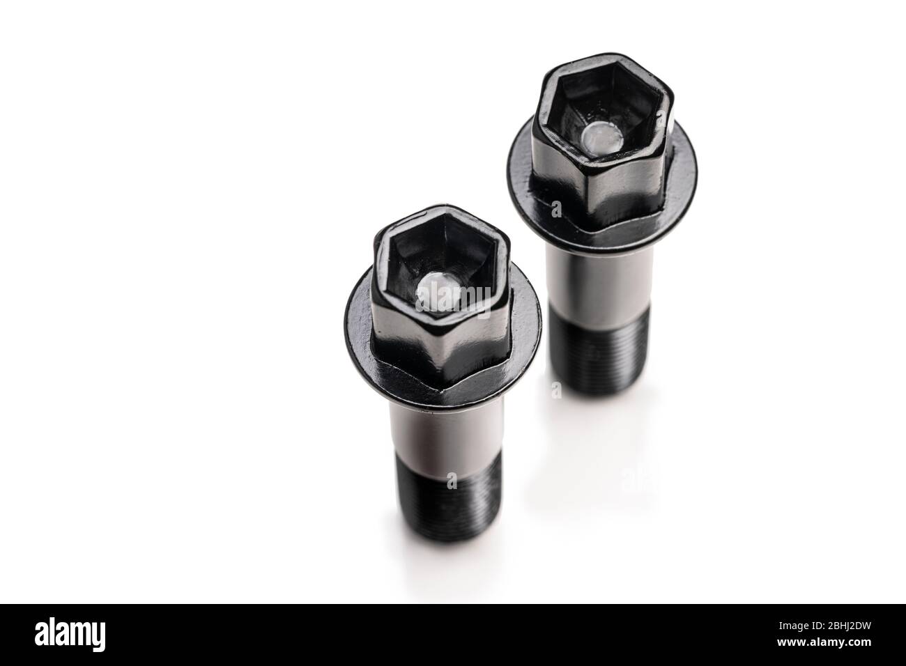 black wheel bolts on a white background, isolate. auto parts top view