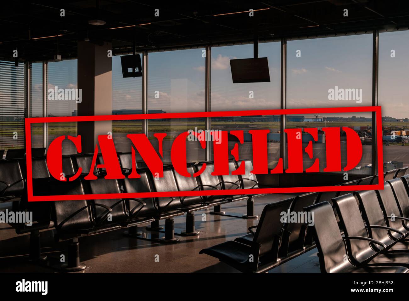 canceled flight concept, empty airport lounge with cancel text - Stock Photo