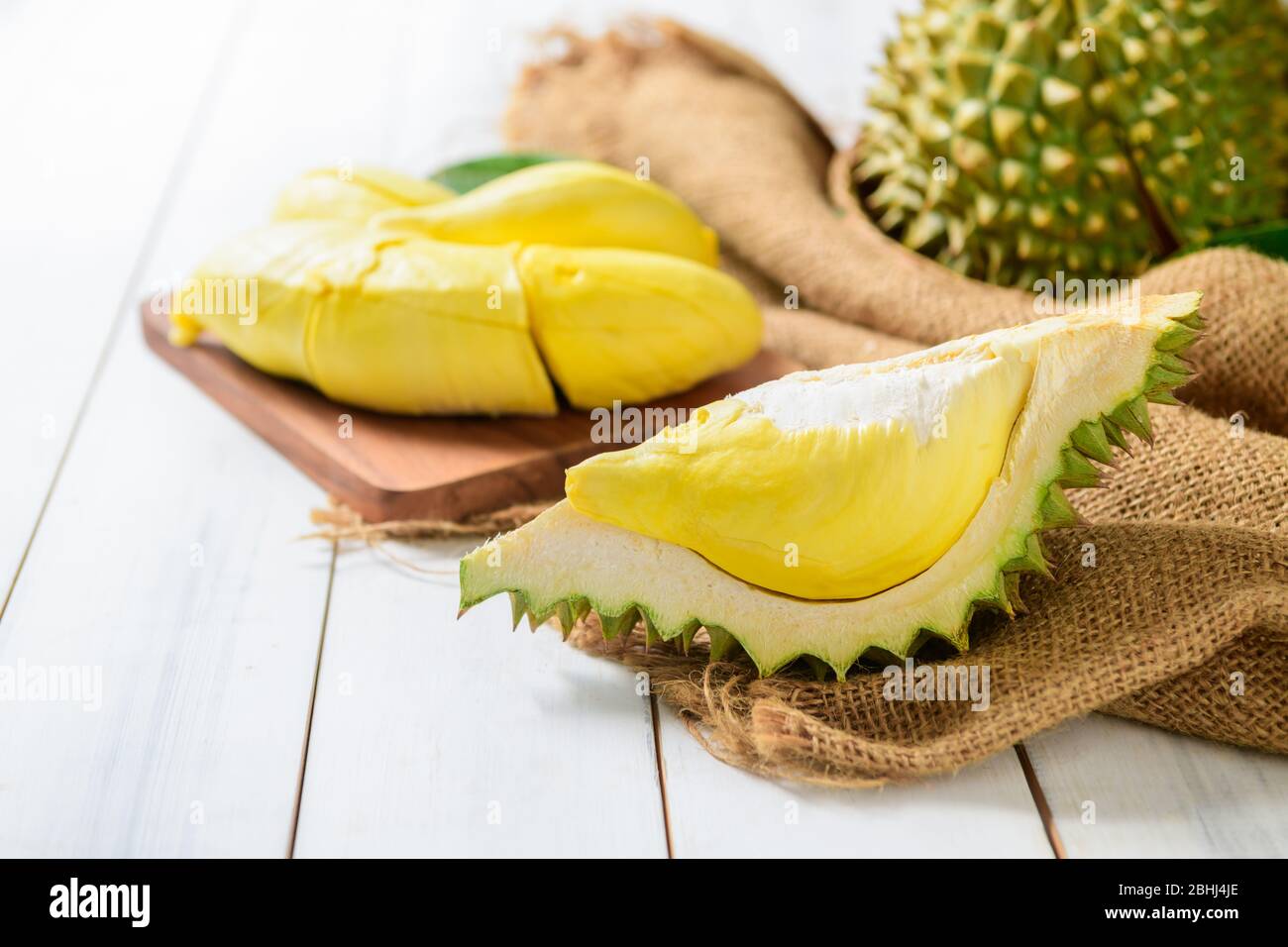Fresh Cut Durian Monthong On Sack And White Wood Background King Of Fruit From Thailand On Summer Season Stock Photo Alamy
