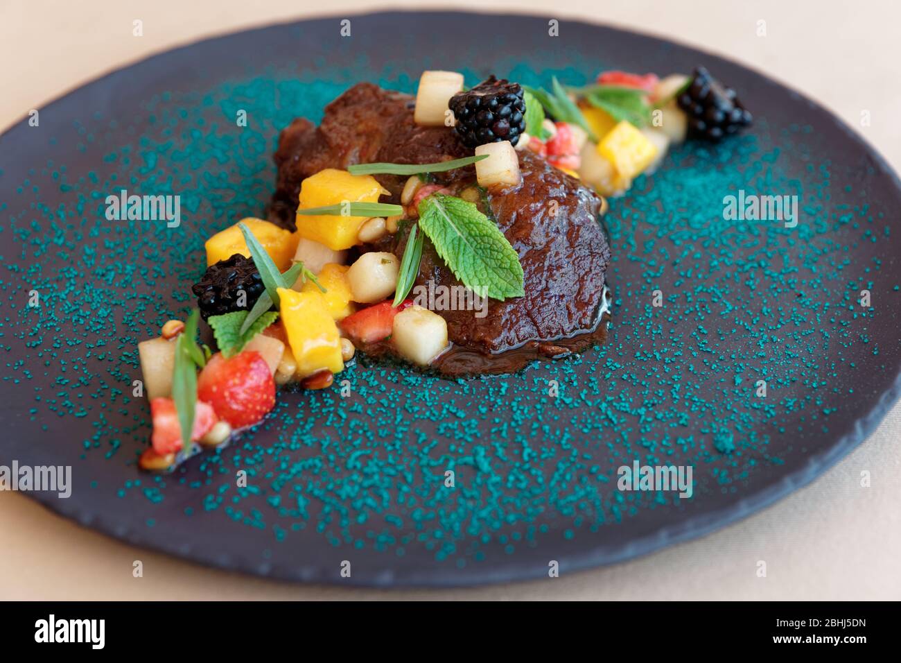 Slowcooked veal cheek with fruits, herbs and berries Stock Photo Alamy