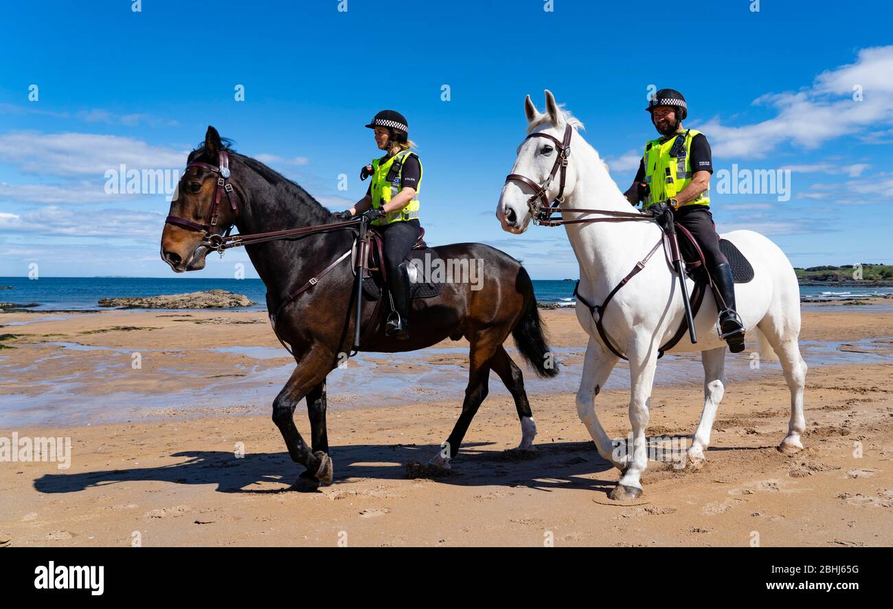North Berwick, Scotland, UK. 26 April 2020. Mounted police patrolling the beaches of North Berwick in East Lothian this afternoon. Horses Inverness (dark) and Edinburgh travelled from their stables in Stewarton in Ayrshire for today’s walk. However the beaches were very quiet and the horses’ main duty was to pose for photographs with the few people outdoors.  Iain Masterton/Alamy Live News Stock Photo