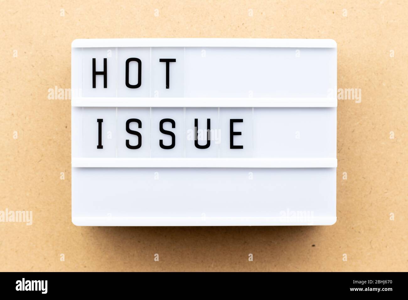 Light box with word hot issue on wood background Stock Photo