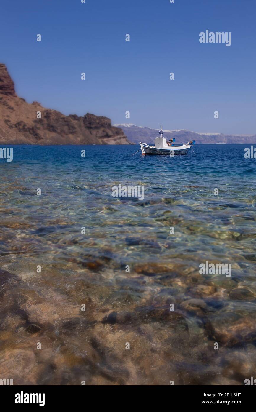 A small boat in Aegean sea, Santorini, Cyclades islands, Greece, Southern Europe Stock Photo