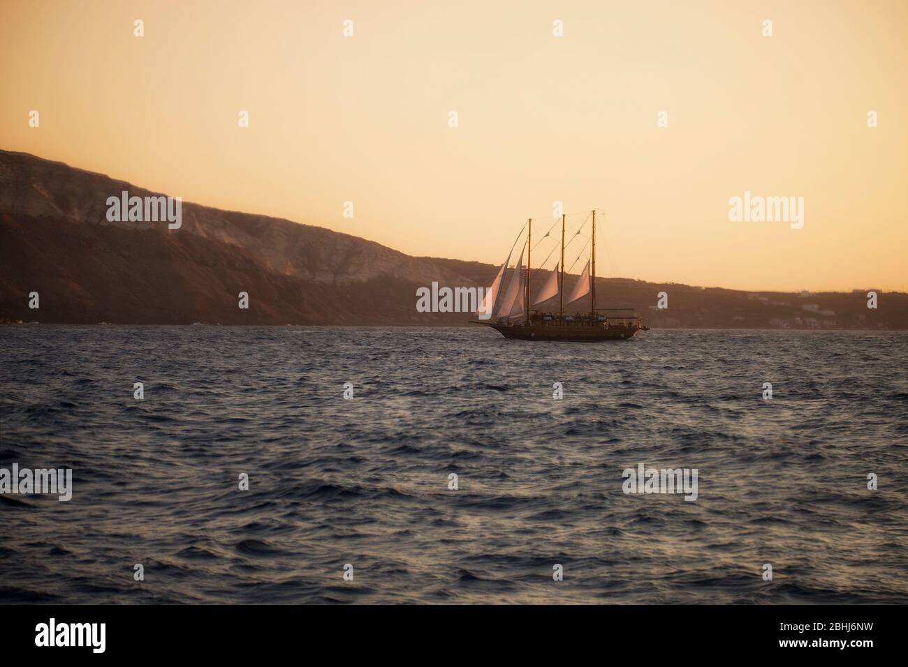 A ship sails in Aegean sea, Santorini, Cyclades islands, Greece, Southern Europe Stock Photo