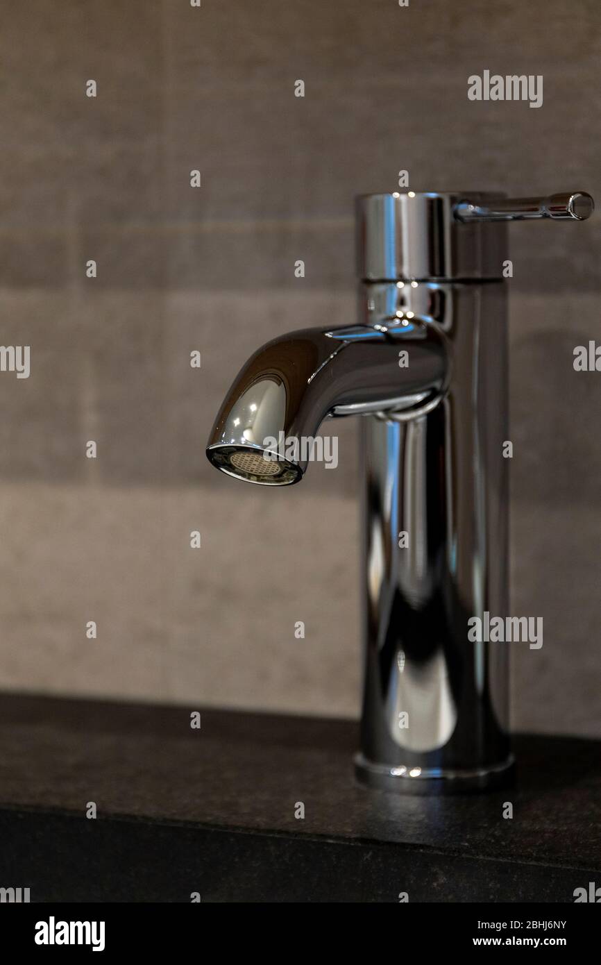 A Portrait Of A Bathroom Faucet With No Water Coming Out Of It The Handle Is Turned To The Cold Water Side Stock Photo Alamy