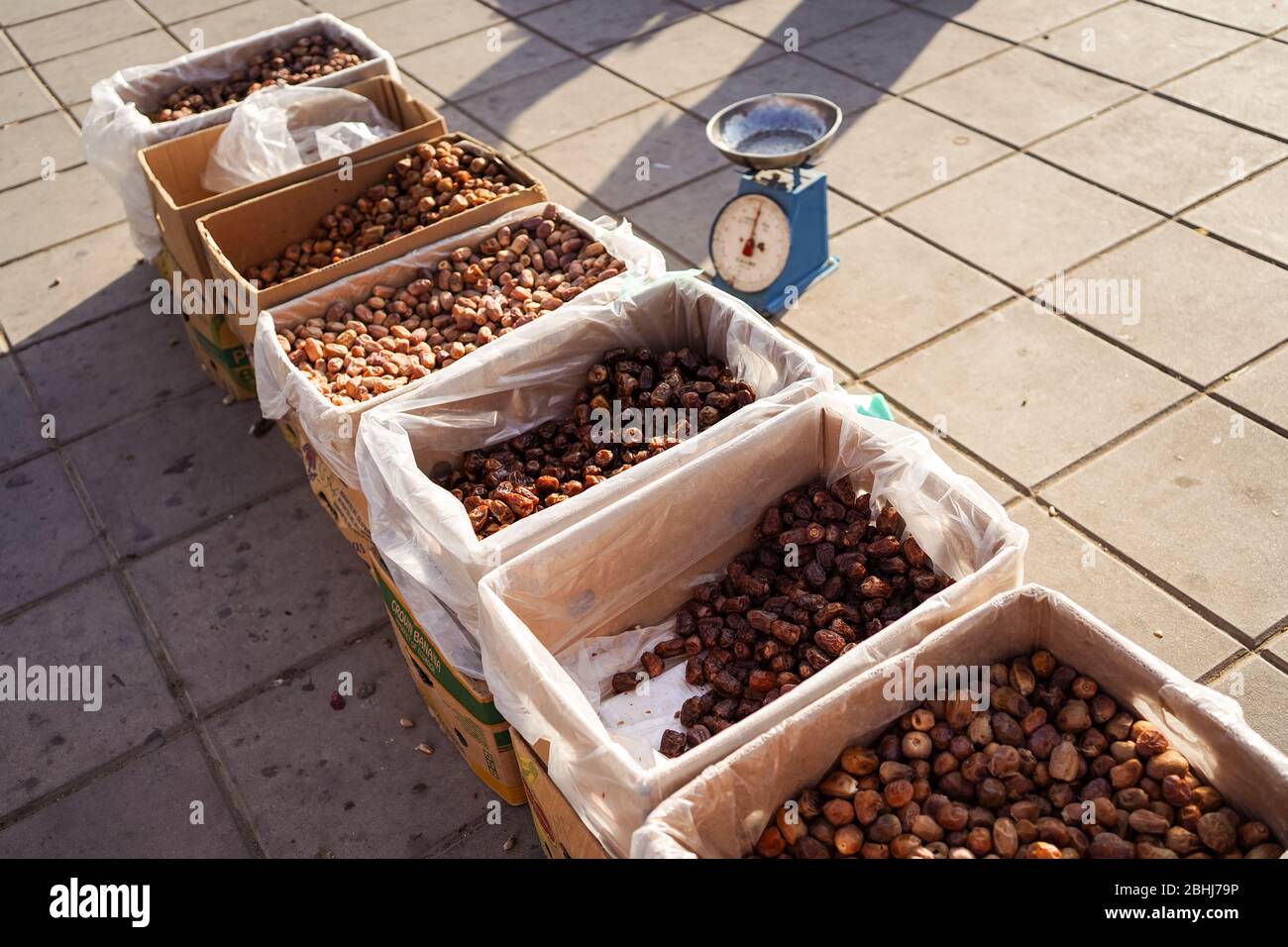Jeddah / Saudi Arabia - January 16, 2020: street stall selling dates with scales in the background Stock Photo