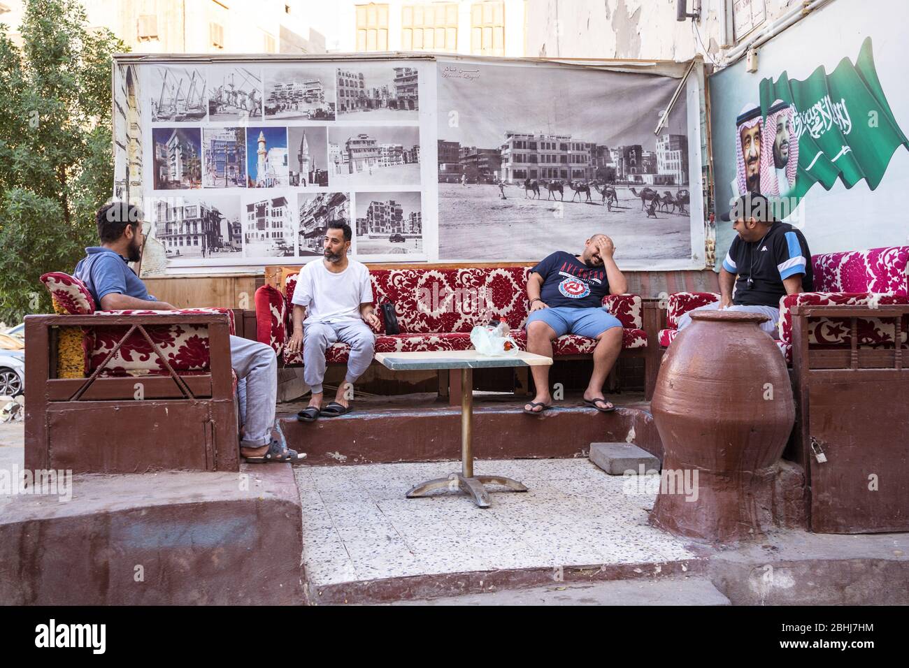 Jeddah / Saudi Arabia - January 16, 2020: young men talking sitting in couches on the streets of central Jeddah Stock Photo