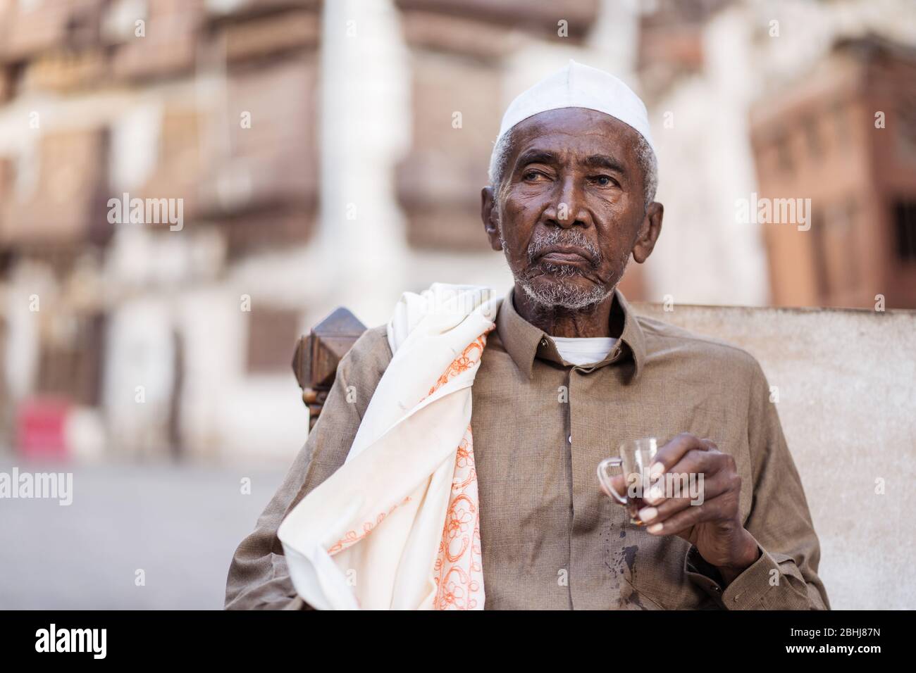 Jeddah / Saudi Arabia - January 16, 2020: portrait of famous traditional carpenter in Al-Balad drinking tea in the streets of downtown Jeddah Stock Photo