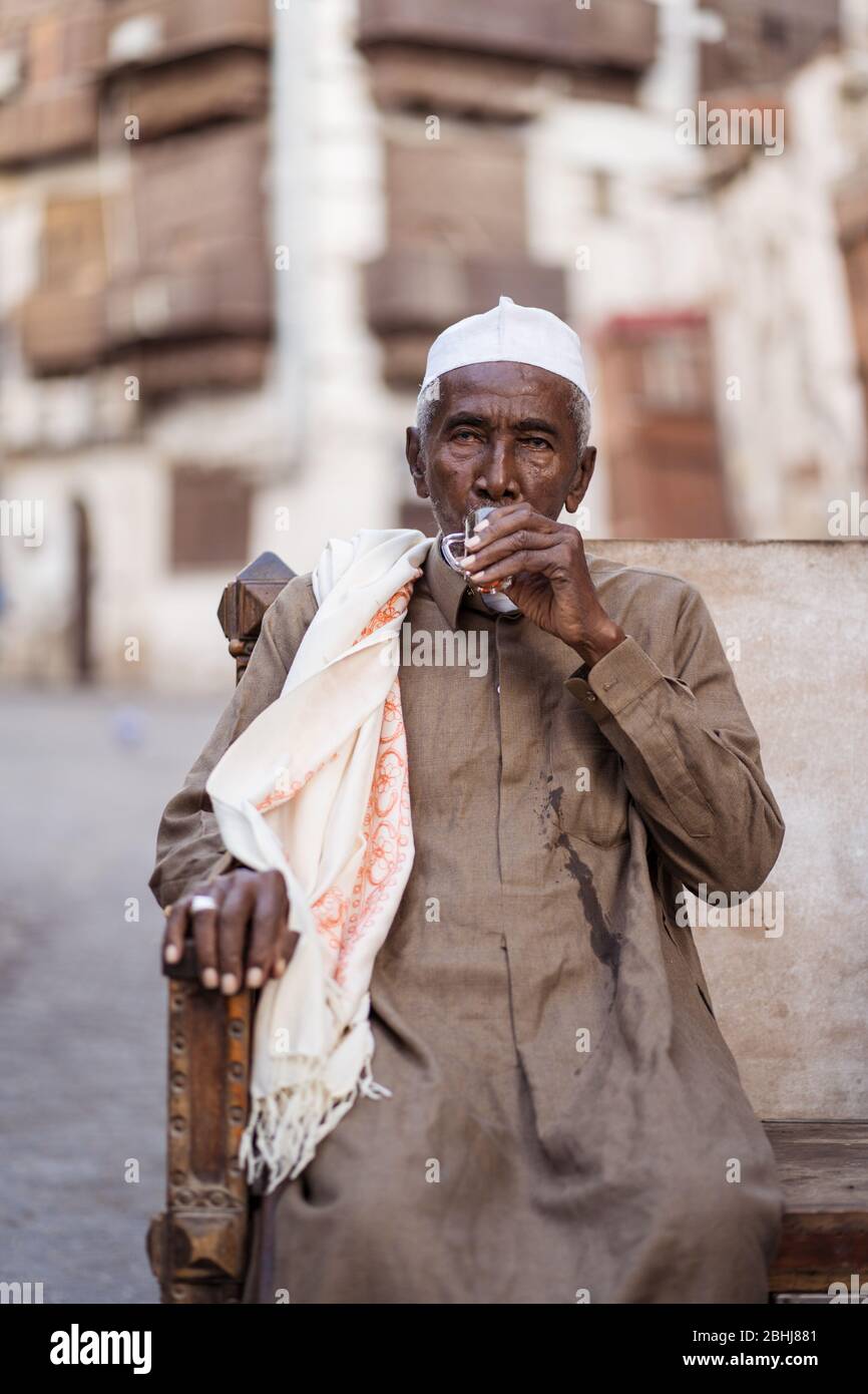 Jeddah / Saudi Arabia - January 16, 2020: portrait of famous traditional carpenter in Al-Balad drinking tea in the streets of downtown Jeddah Stock Photo