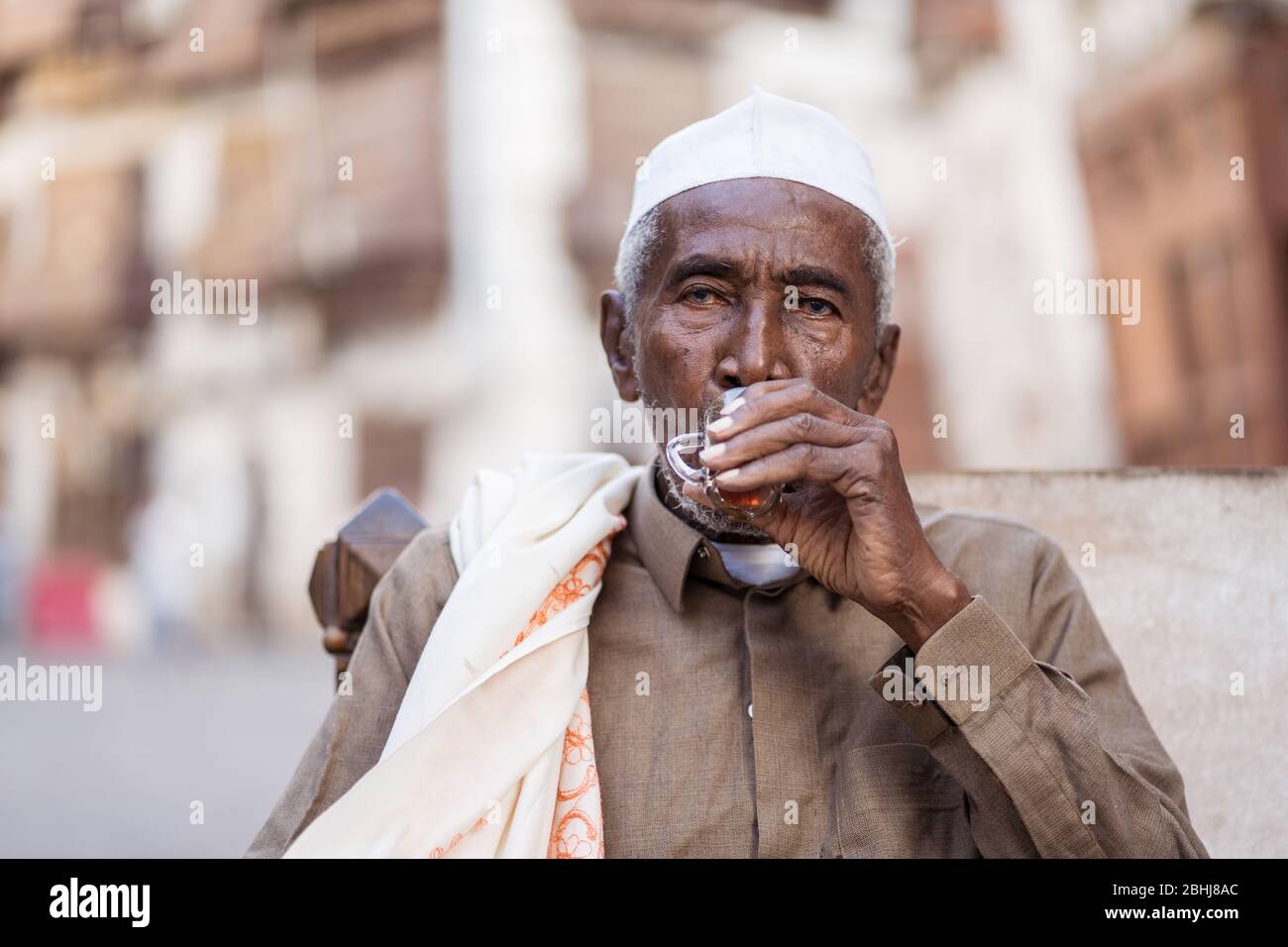 Jeddah / Saudi Arabia - January 16, 2020: portrait of famous traditional carpenter in Al-Balad drinking tea in the streets of downtown Jeddah Stock Photo