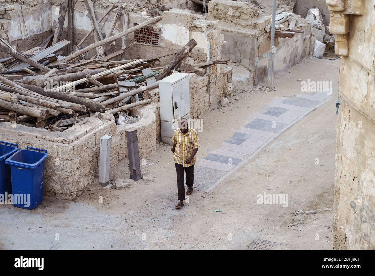 Jeddah / Saudi Arabia - January 16, 2020: One man wearing modern clothes walking alone in the streets of Jeddah downtown Stock Photo