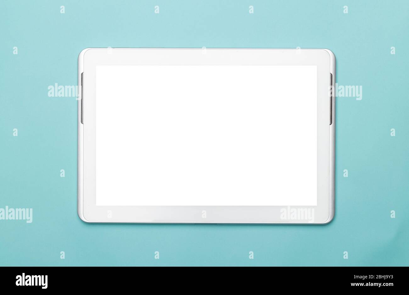 White tablet computer with blank screen mockup isolated on blue background. Clipping path. Stock Photo