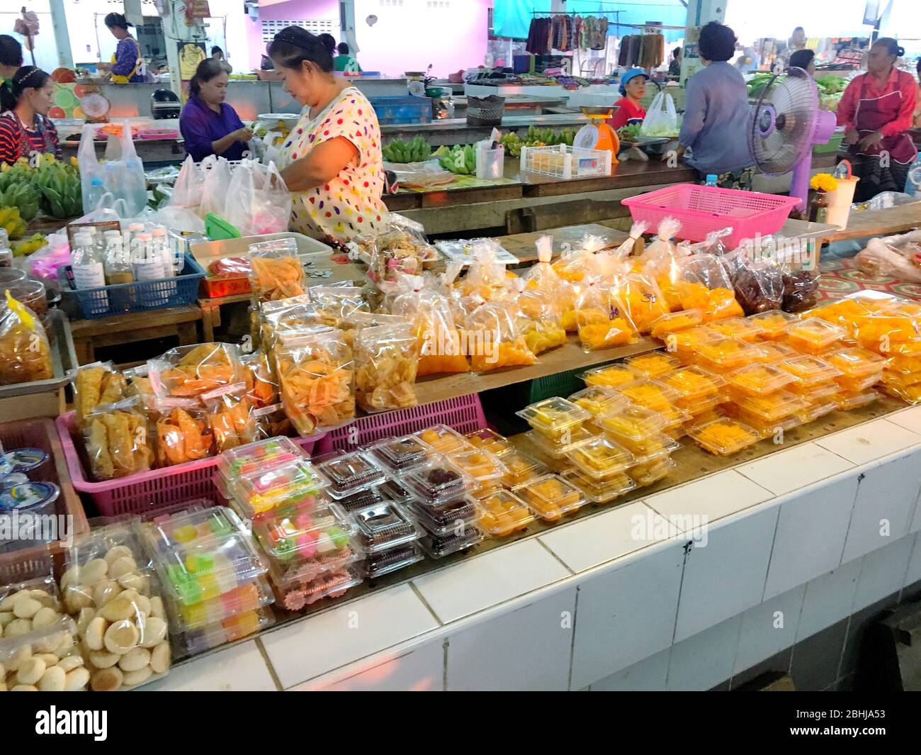 Photo of An old lady with her many kinds of traditional Thai sweets in ...