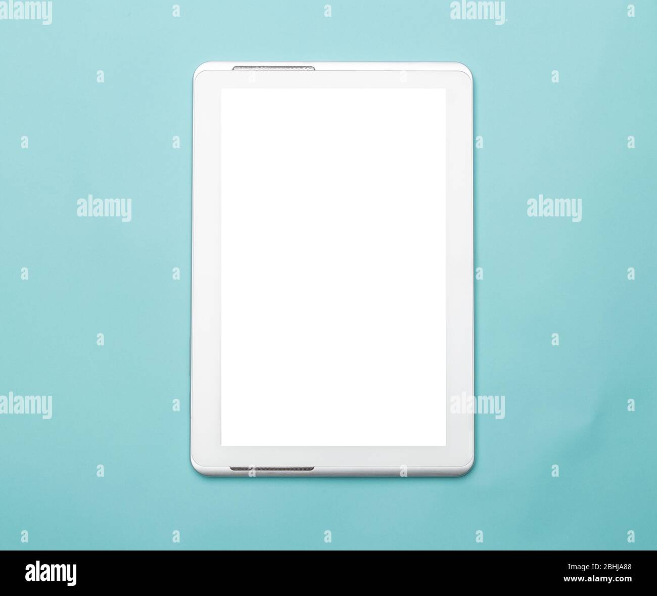 White tablet computer with blank screen mockup isolated on blue background. Clipping path. Stock Photo