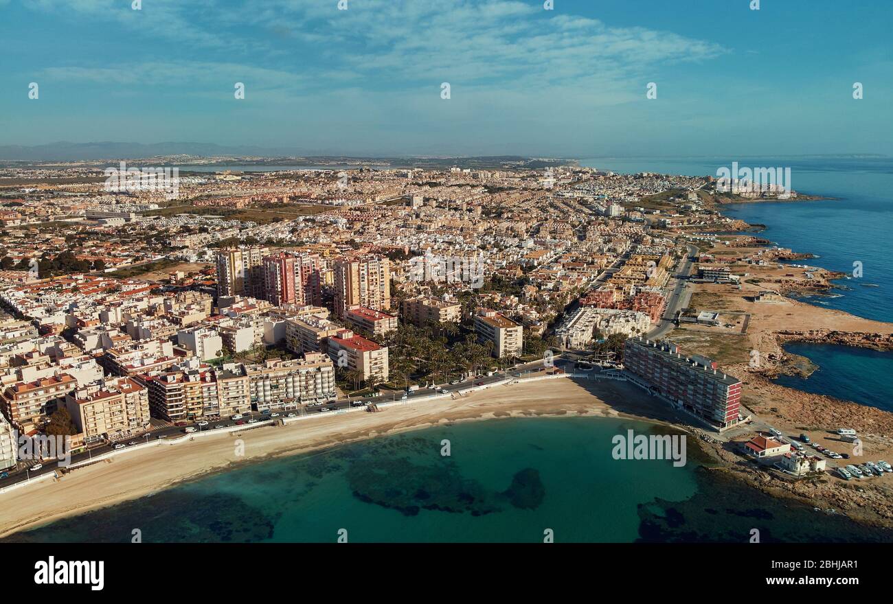 Distant aerial panorama Los Locos coastline, drone point of view, calm Mediterranean Sea, photo taken during corona virus lockdown beaches are closed. Stock Photo