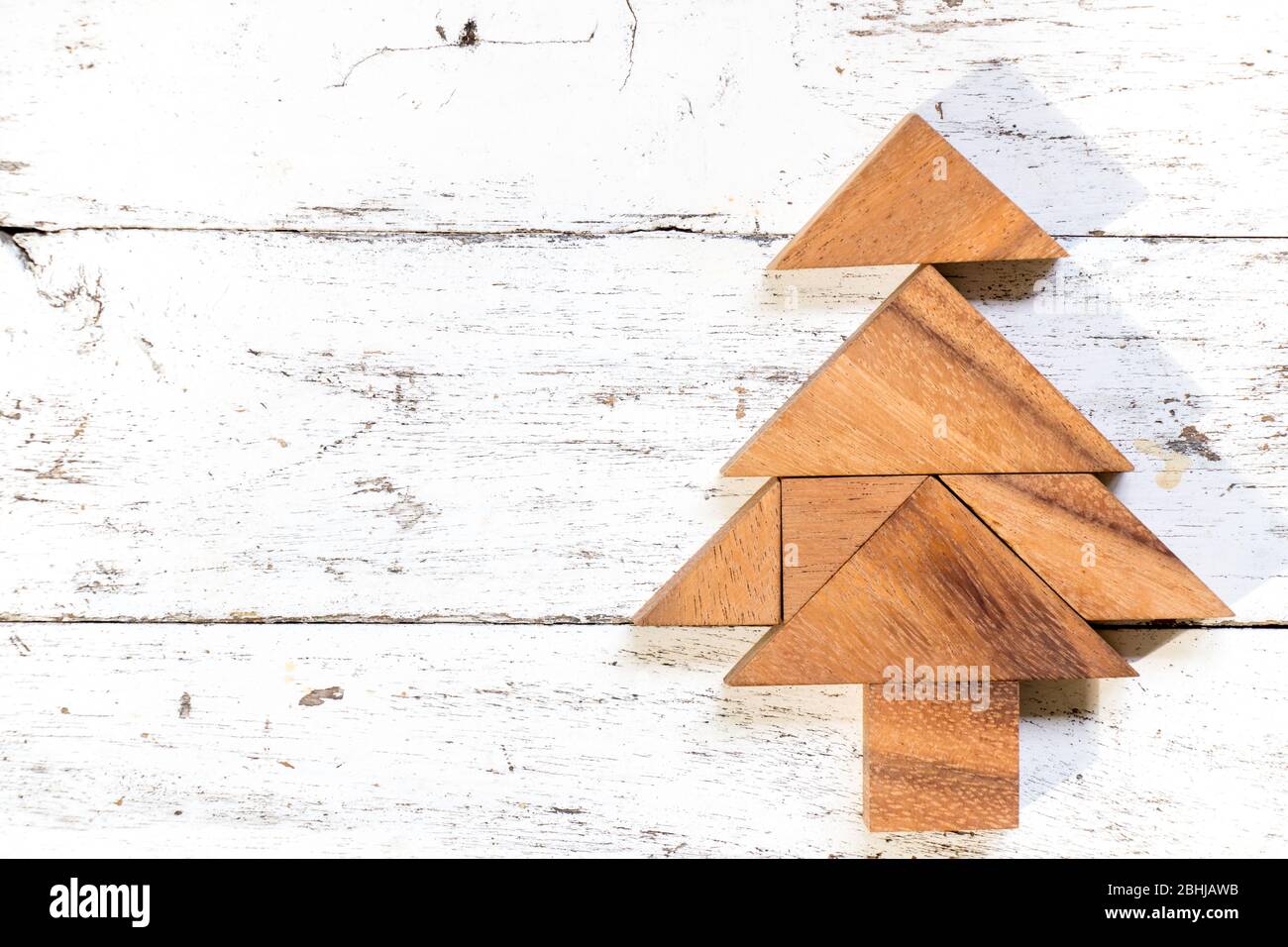 Tangram puzzle in christmas or pine tree shape on old white wood ...