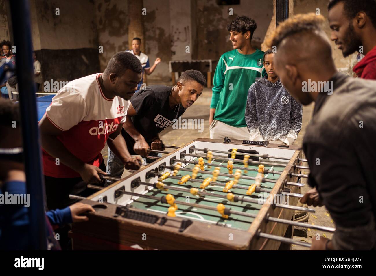 Jeddah / Saudi Arabia - January 16, 2020: group of young boys play video games, pool or table football in a park in the historic center of Jeddah Stock Photo