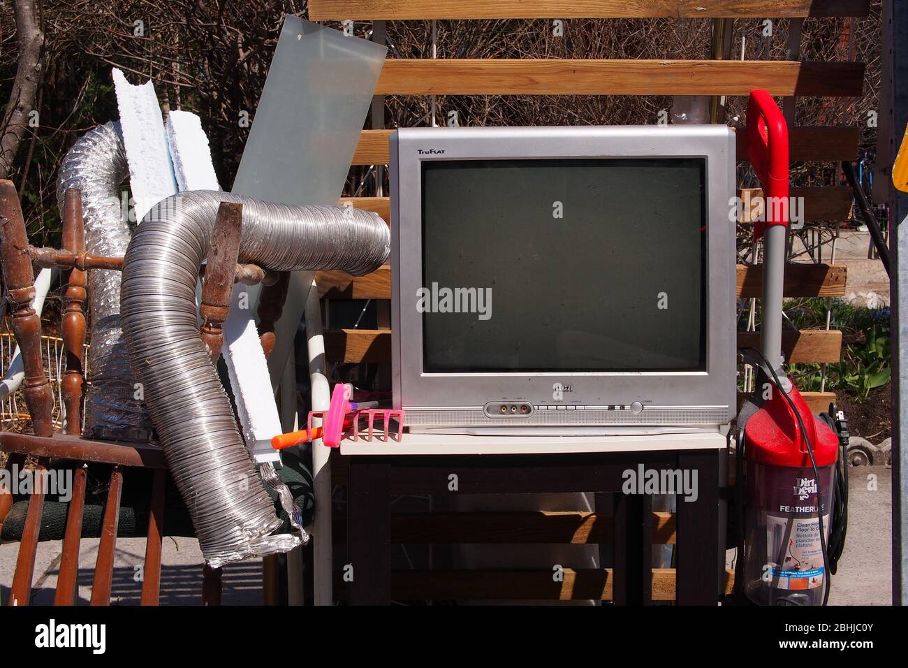 Large item garbage collection day pile of broken furniture and