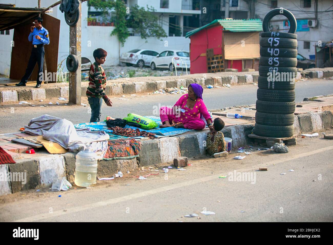 poor indian family living in the rods streets of india,poverty in india,delhi streets,indian streets,poor indian family,street kids in india,asia Stock Photo