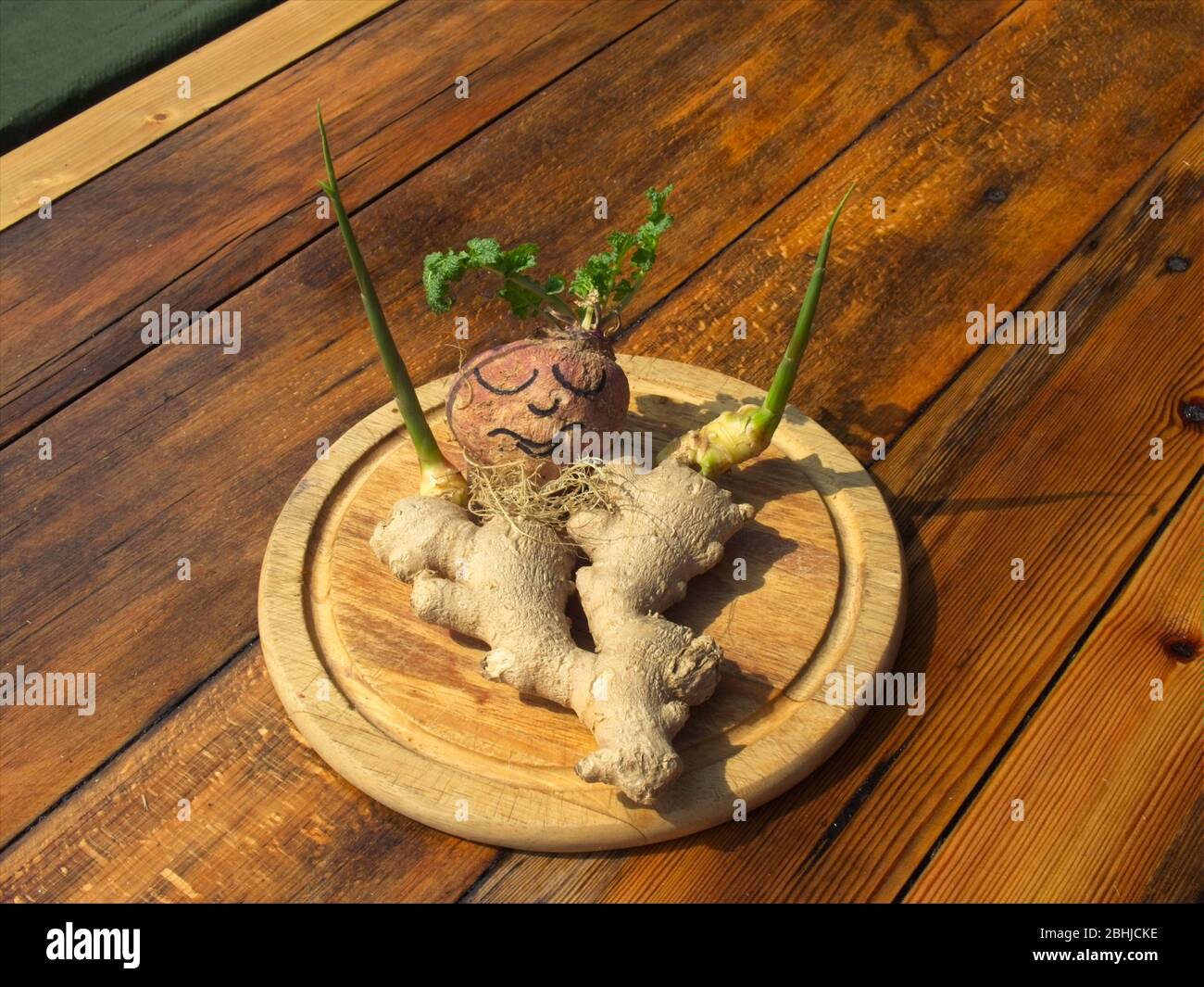 Arrangement with ginger and beet root on a table top. Stock Photo