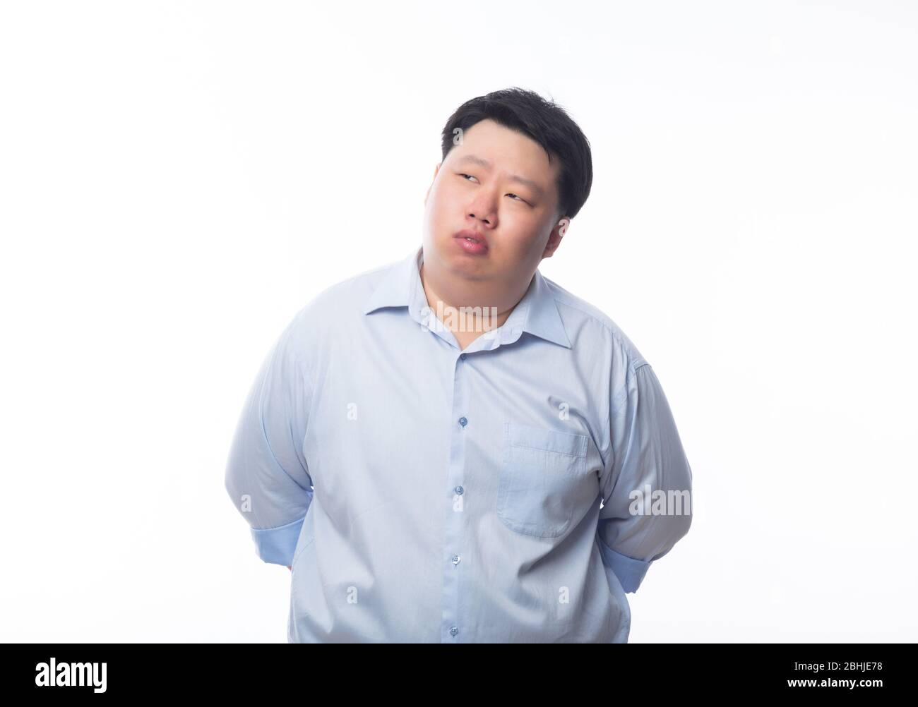 Asian fat man in blue shirt thinking and looking to copyspace isolated ...