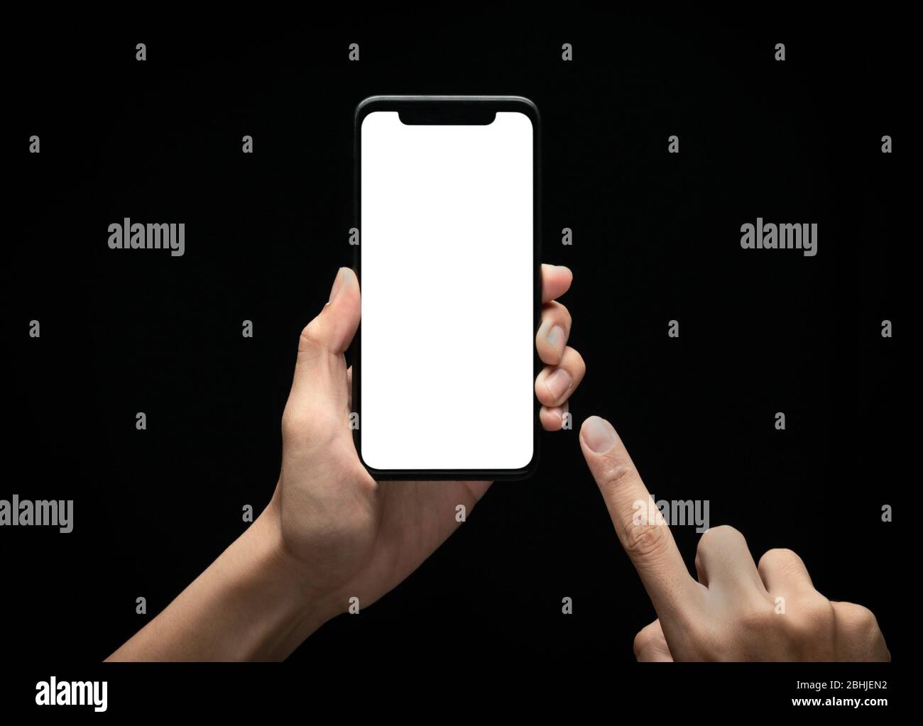 Male hands holding and using smartphone with blank screen at night ...