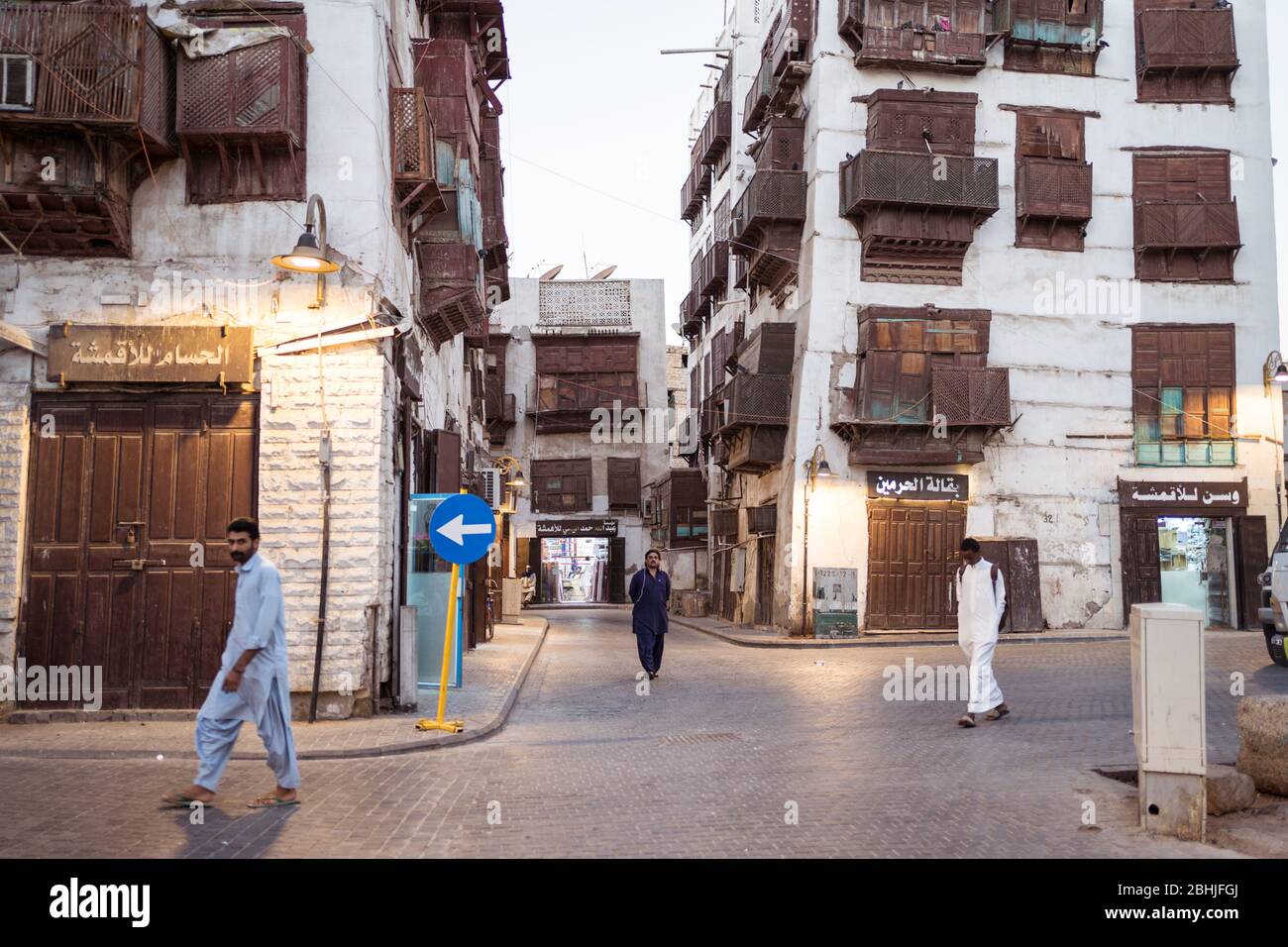 Jeddah / Saudi Arabia - January 16, 2020: Night view of street of old town historic Al-Balad with people walking and wooden balconies in buildings Stock Photo
