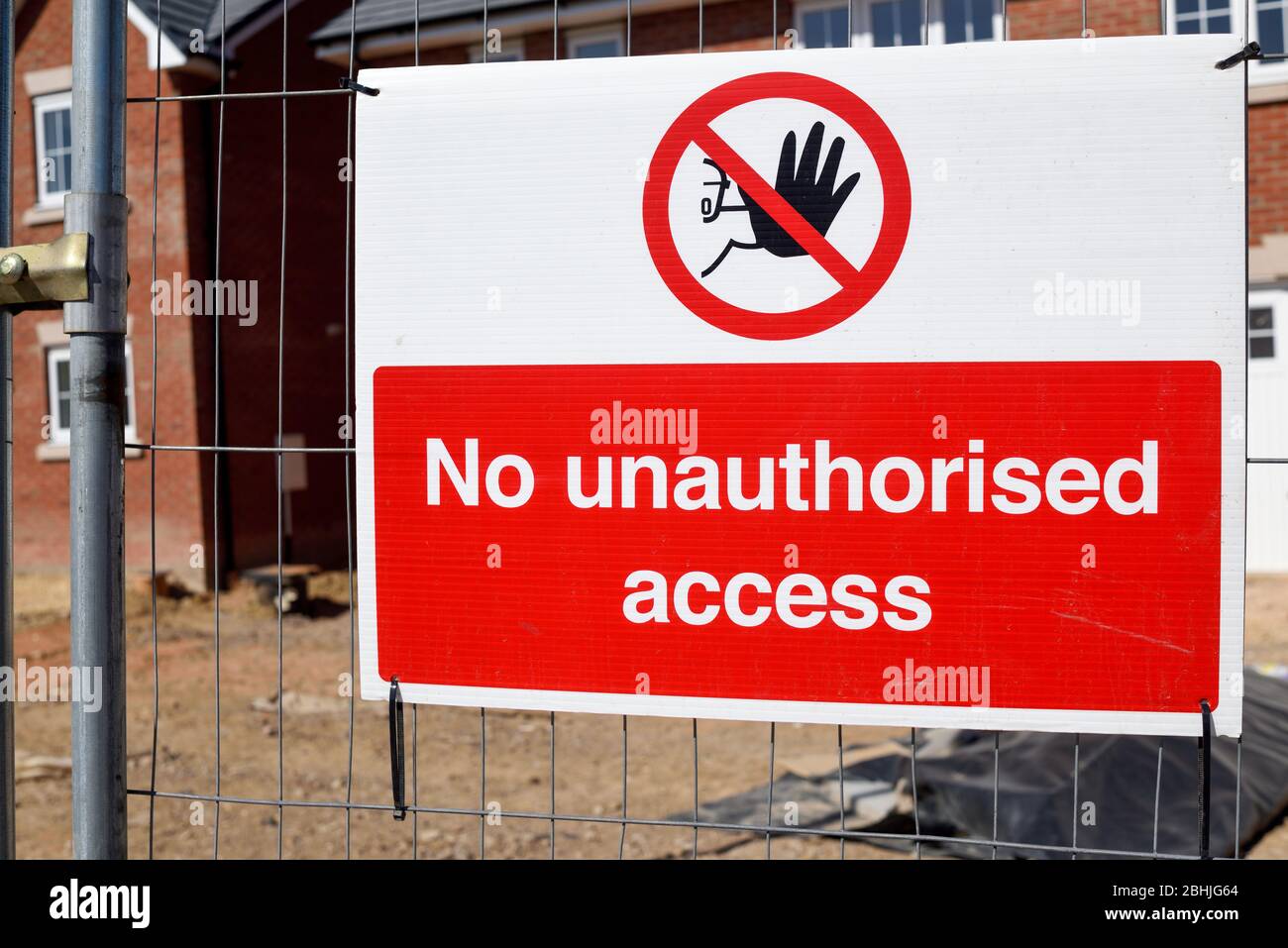 Construction site-building of new homes health and safety warning notice on a metal fence Stock Photo