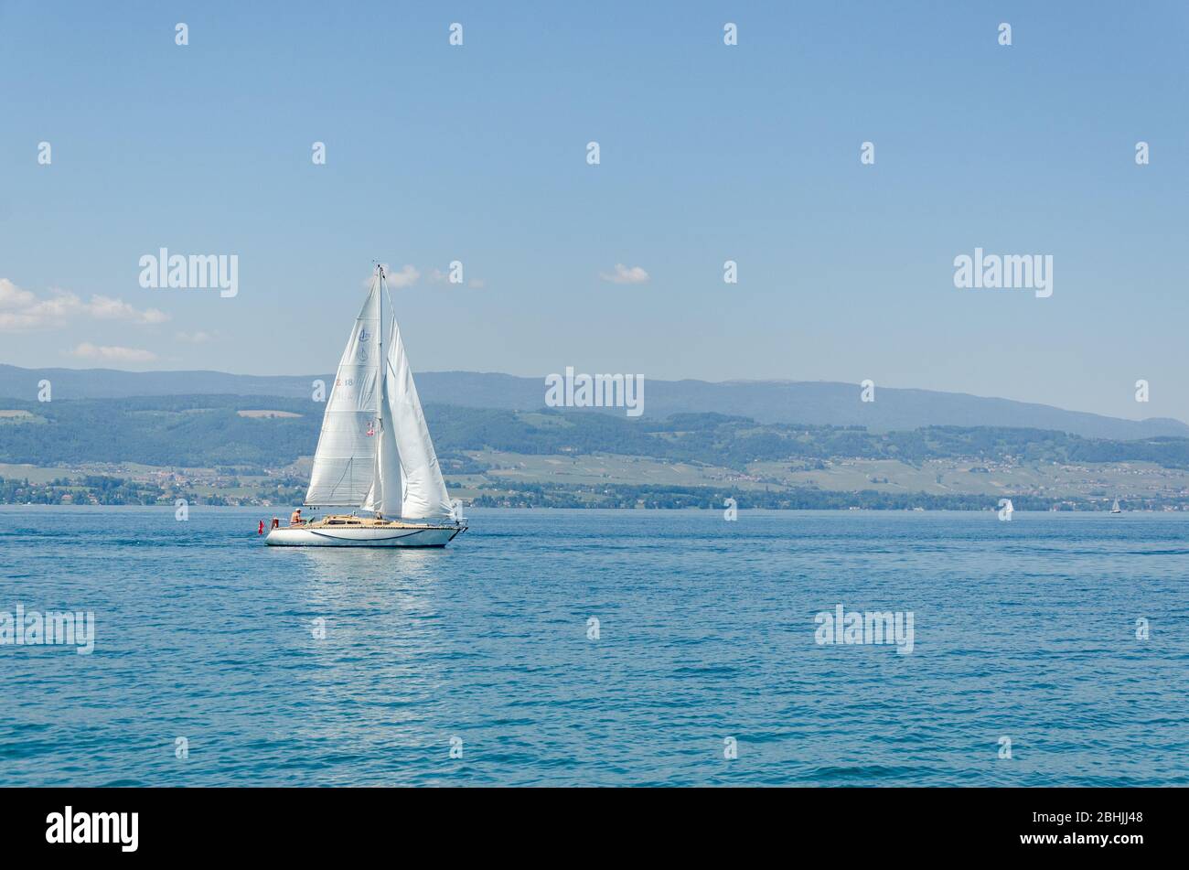 View of a small sailing yacht in Lake Geneva as seen from Port d'Yvoire, Yvoire, France Stock Photo