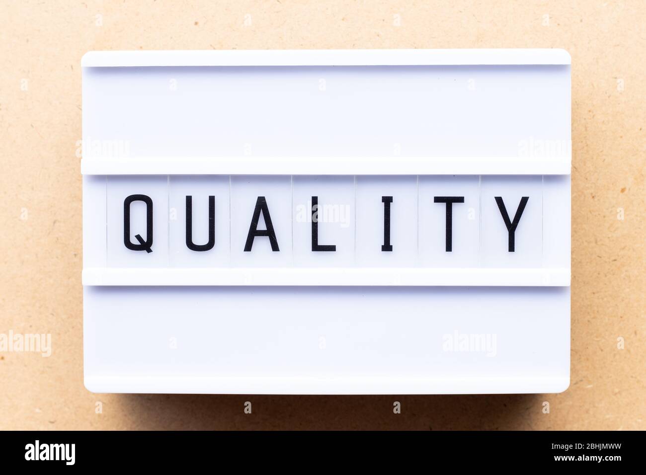 Lightbox with word quality on wood background Stock Photo