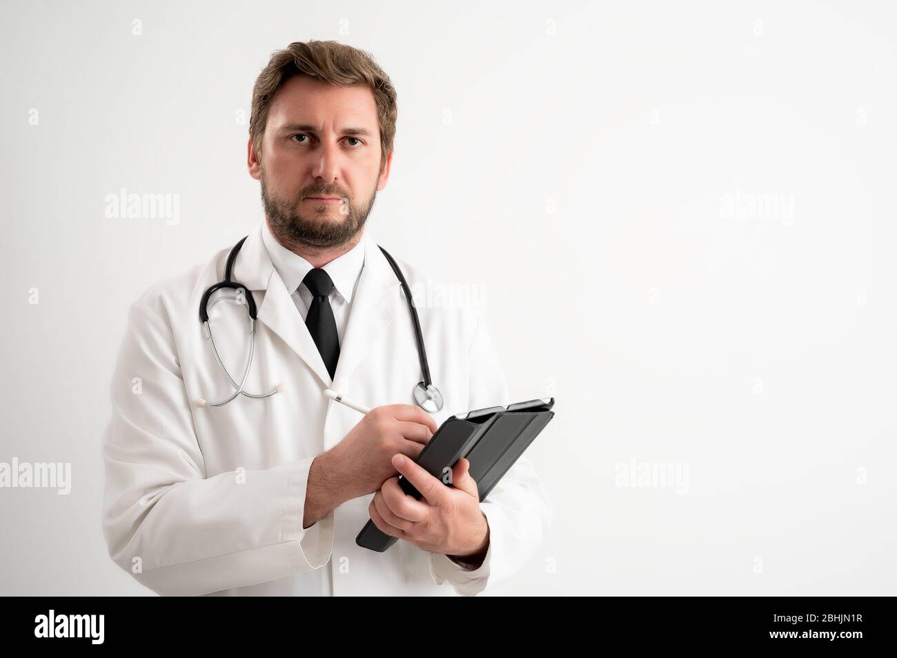 Portrait of beautiful woman doctor with stethoscope wearing red scrubs