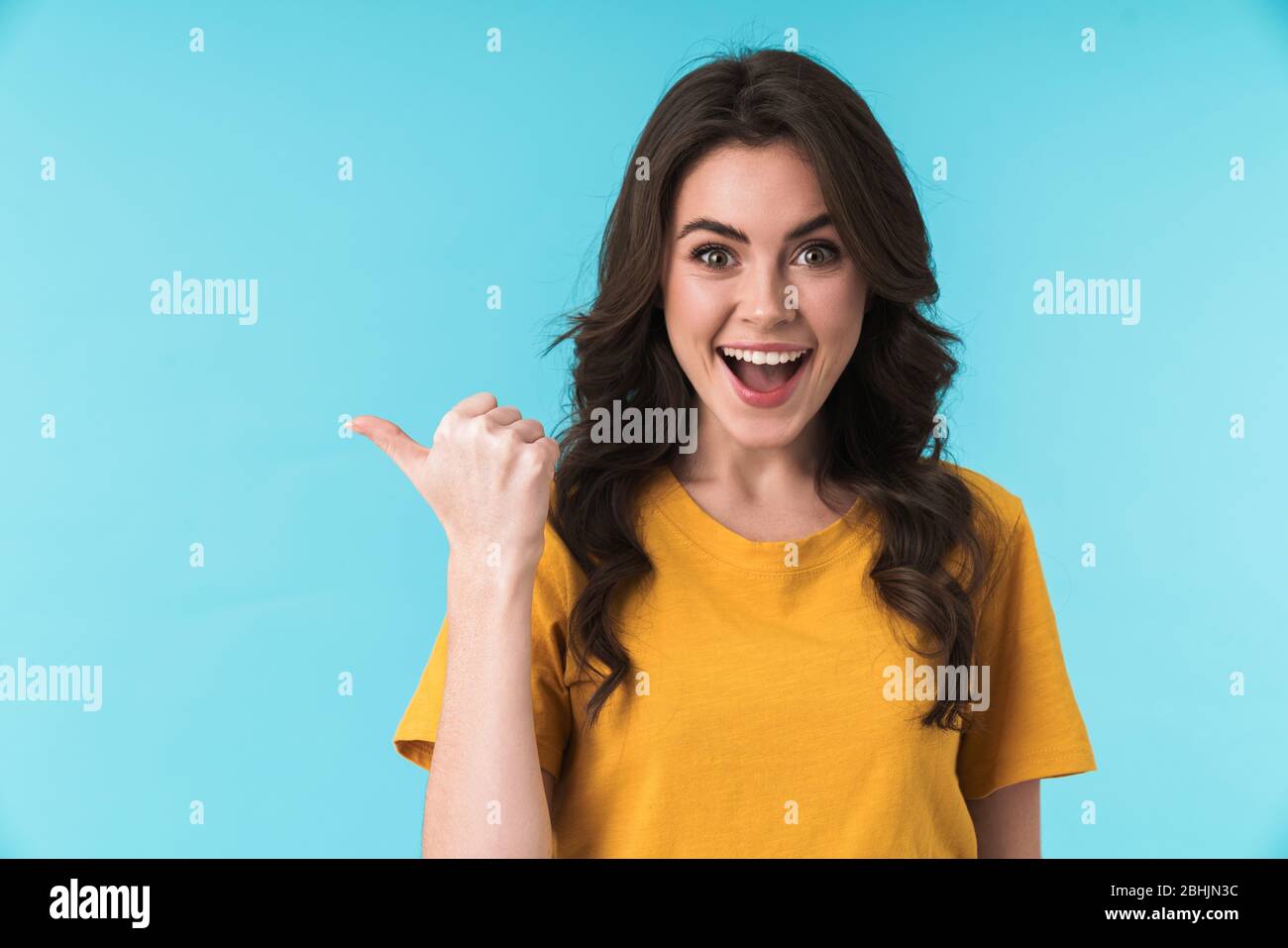 Photo of a positive surprised young pretty woman posing isolated over ...