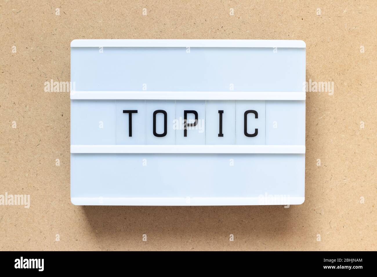 White lightbox with word topic on wood background Stock Photo
