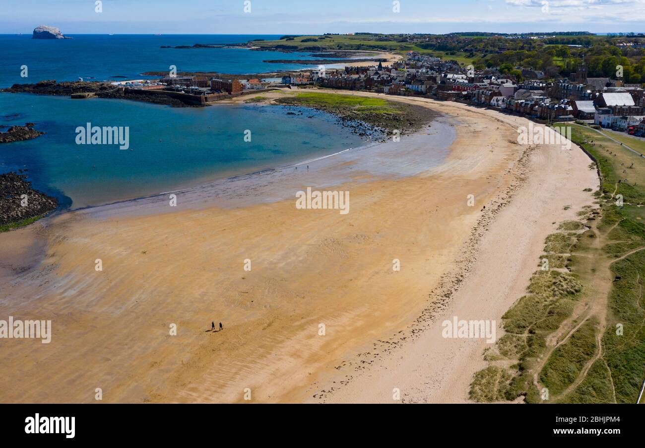 North Berwick, Scotland, UK. 26 April 2020. View of beach at North Berwick with very few people outdoors. Lockdown seems to be taken seriously in North Berwick with empty beaches and streets normal over the last month. An aerial view of the almost deserted West Beach at North Berwick  Iain Masterton/Alamy Live News Stock Photo