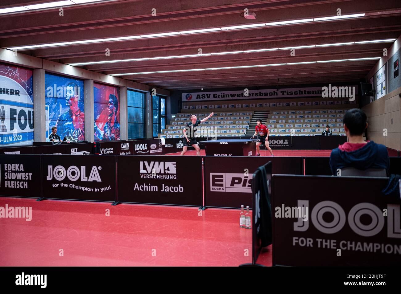 Deni Kozul (front/ASV Gruenwettersbach) and Liang Qiu play in an empty  hall. In the background there are cardboard stands on the empty stand  instead of the spectators. GES/table tennis/1. Bundesliga: In times