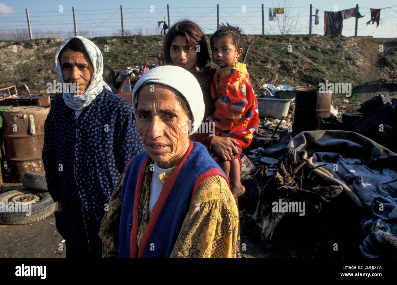 Roma family living in squalid conditions at the Vardarishte landfill site by the Vardar river in Skopje, Macedonia. The Roma have built shacks by the dump and rummage through the waste in which they live in, sometimes finding plastic or metal they can sell. Stock Photo