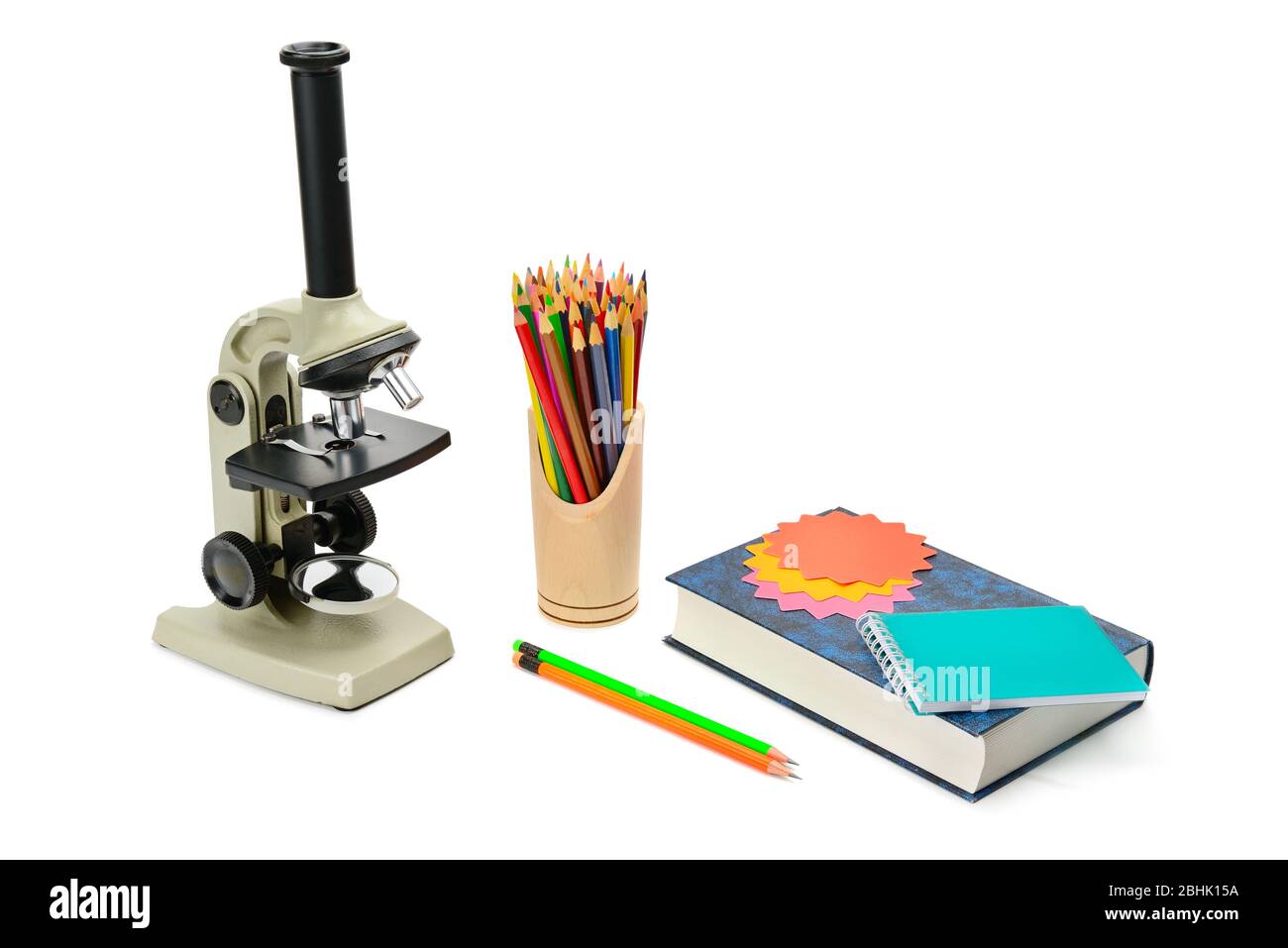 Laboratory microscope, textbook and other school supplies isolated on ...