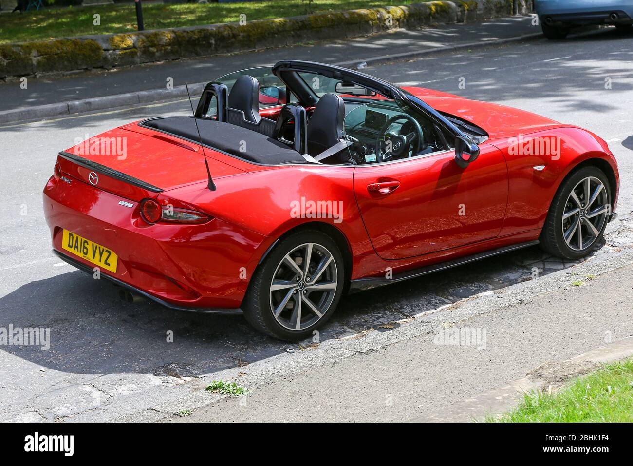A red Mazda MX-5 soft top or convertible sports car, England, UK Stock Photo