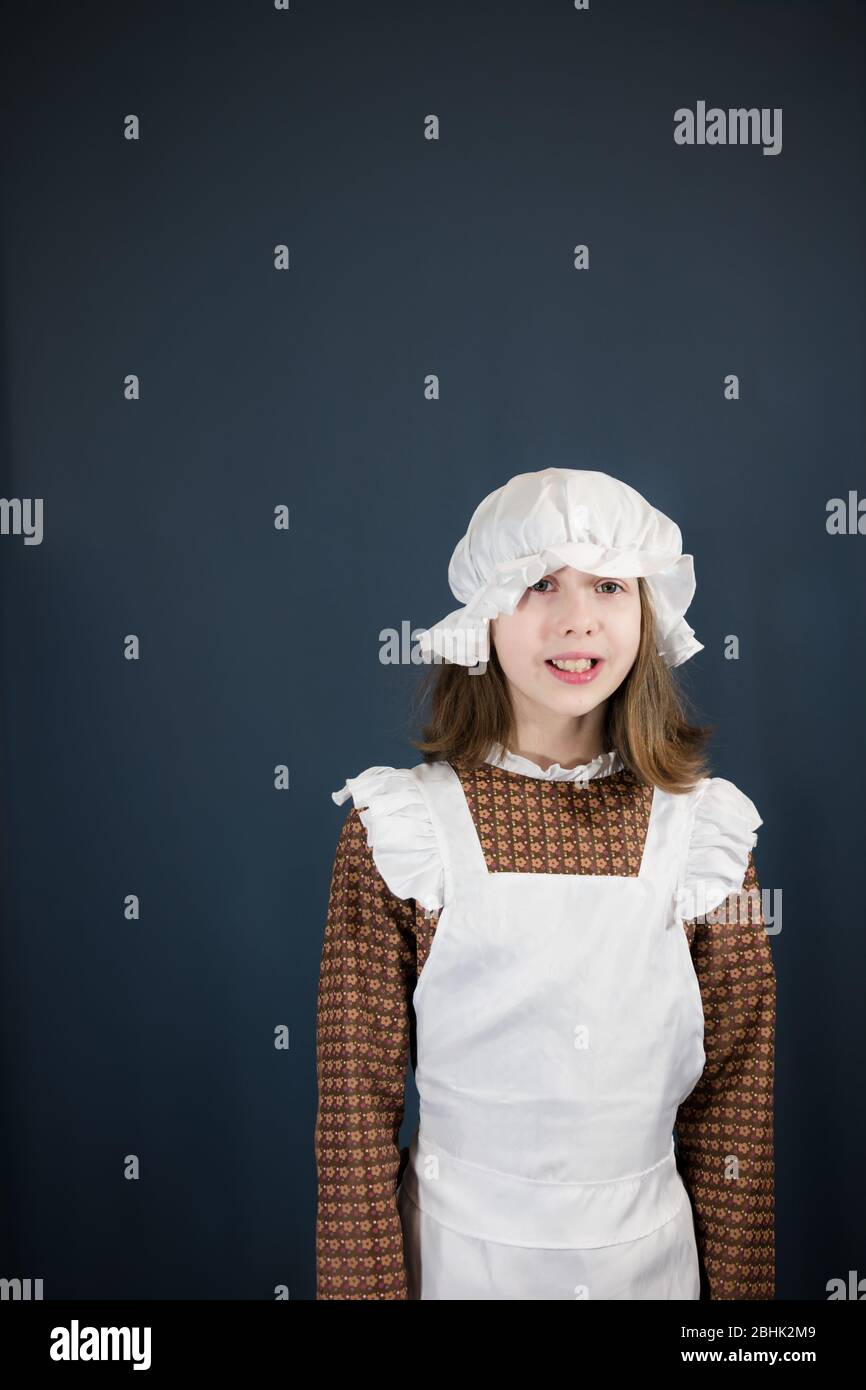 A girl in Victorian maid schoolgirl or maid outfit - with white space Stock Photo